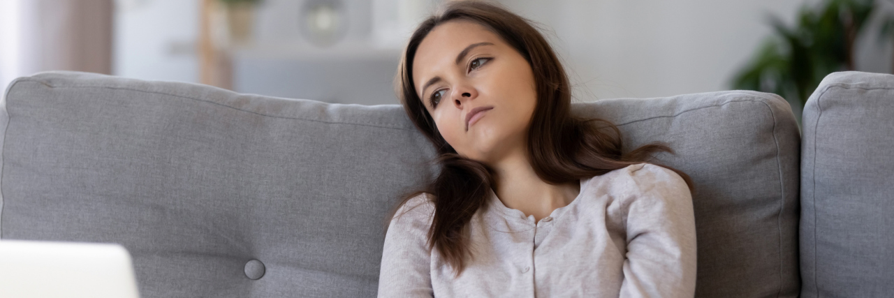 7 Tips for Passing the Time While Self-Quarantined Tired apathetic teenager looking away sitting on couch disinterested in study work, unhappy depressed thoughtful young woman bored alone at home feeling demotivated melancholic lost in thoughts