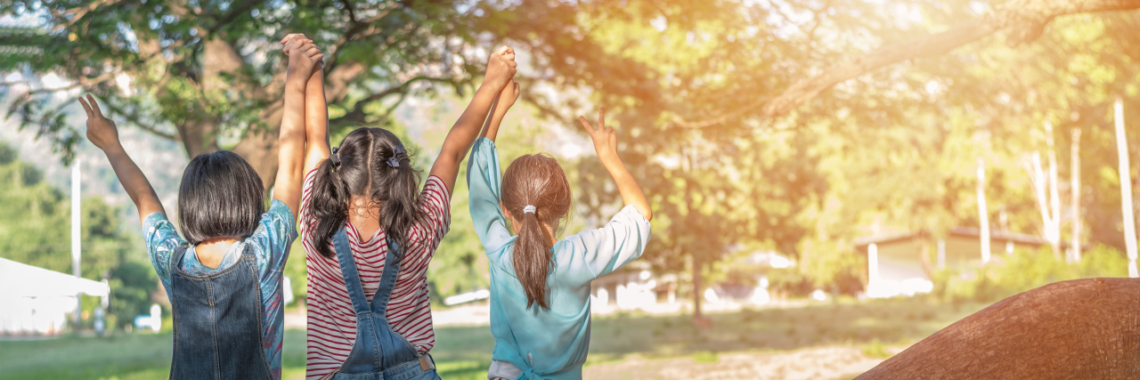 Why Comparing Our Children's Diagnoses Isn't Helpful Children playing in the park.