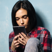 Woman upset by what she sees on her phone.