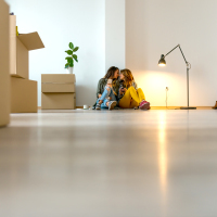 lesbian couple sitting in a new apartment, kissing