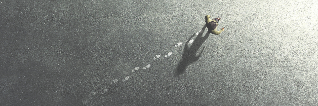 Autistic During the COVID-19 Outbreak and Struggling With Change man walking in the streets leaving footsteps on the ground