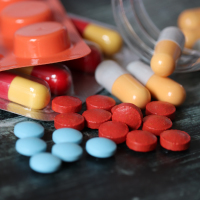 Pills and capsules on table.