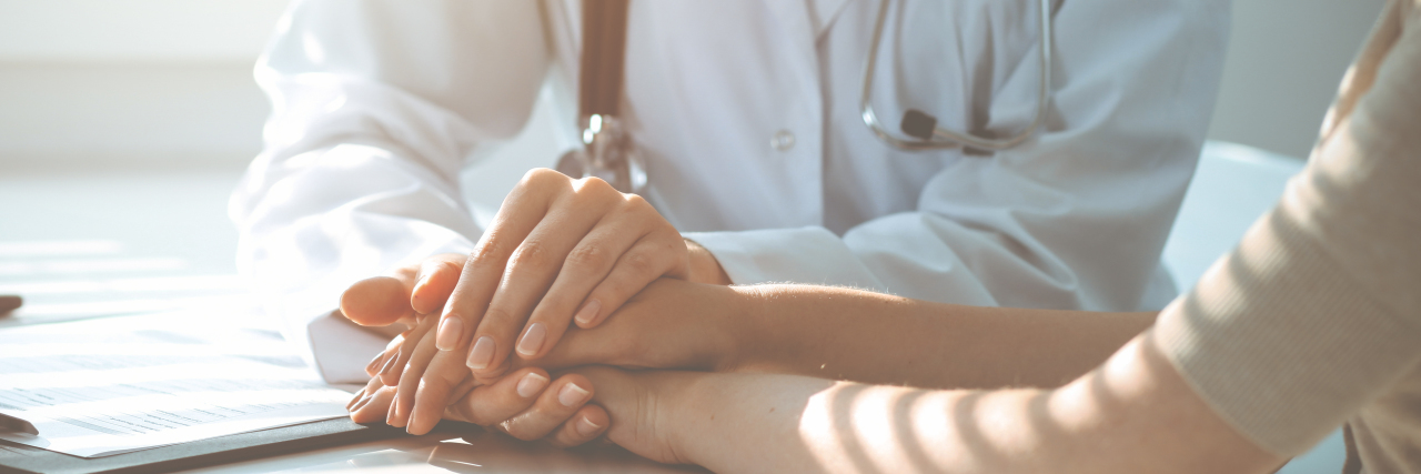 Thank You to My Doctors Who Tirelessly Work to Treat My Rare Disease Doctor holding patient's hand, reassuring them