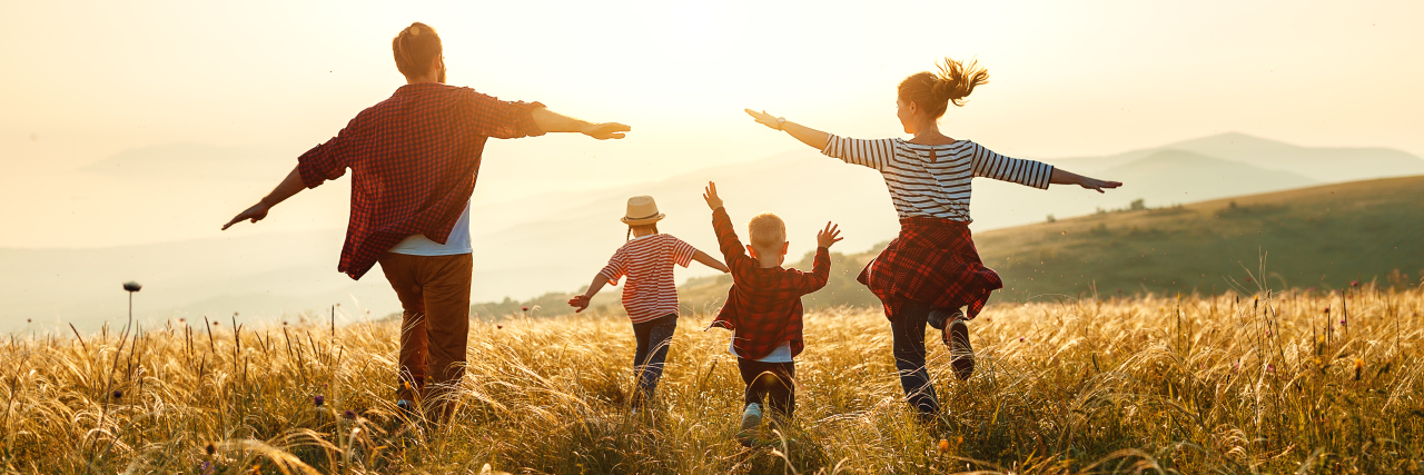 Creating Your Vision for a Good Life With a Disability Happy family: mother, father, children at sunset.