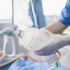 Doctor holding oxygen over patients in ICU/Emergency Room