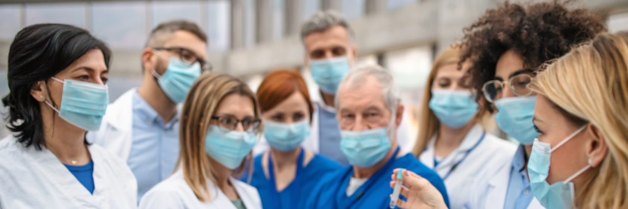 To the Medical Professionals On the Front Lines Fighting COVID-19 Group of doctors talking about coronavirus.