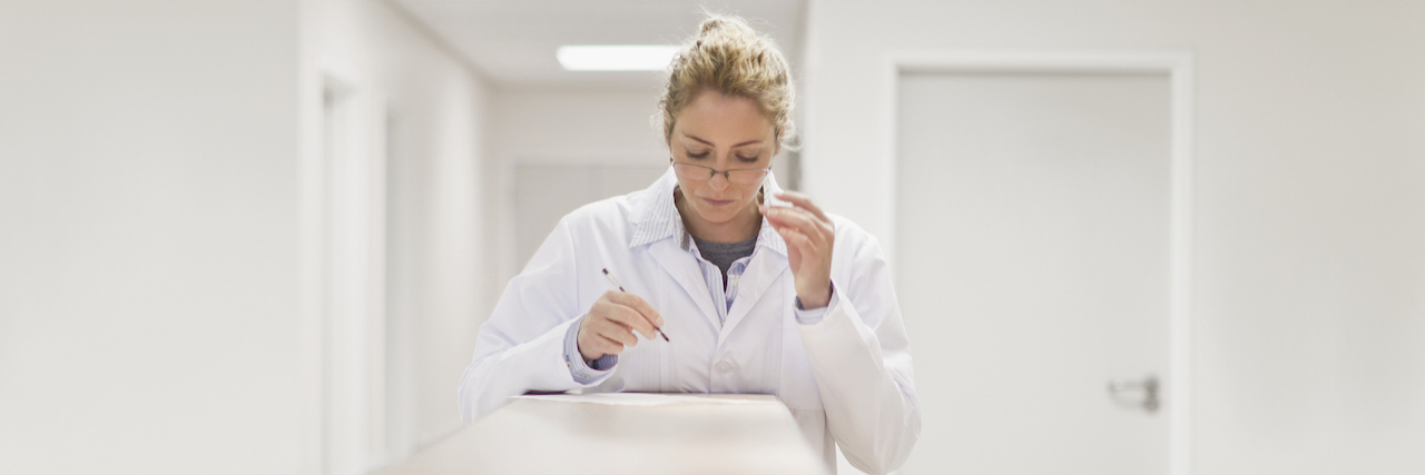 Female doctor examining paperwork