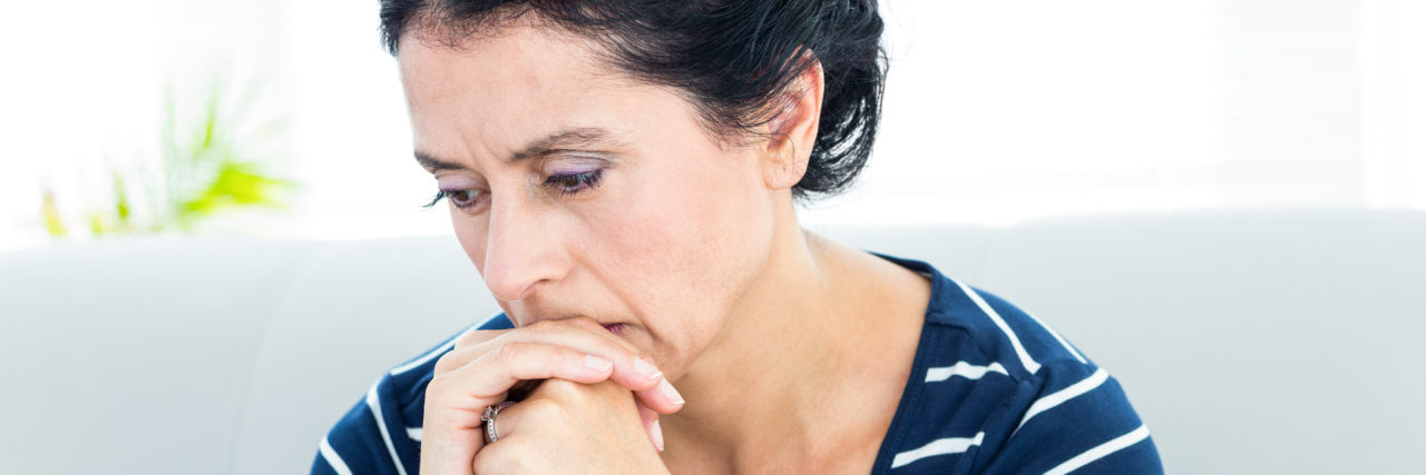 Unhappy woman sitting on the couch