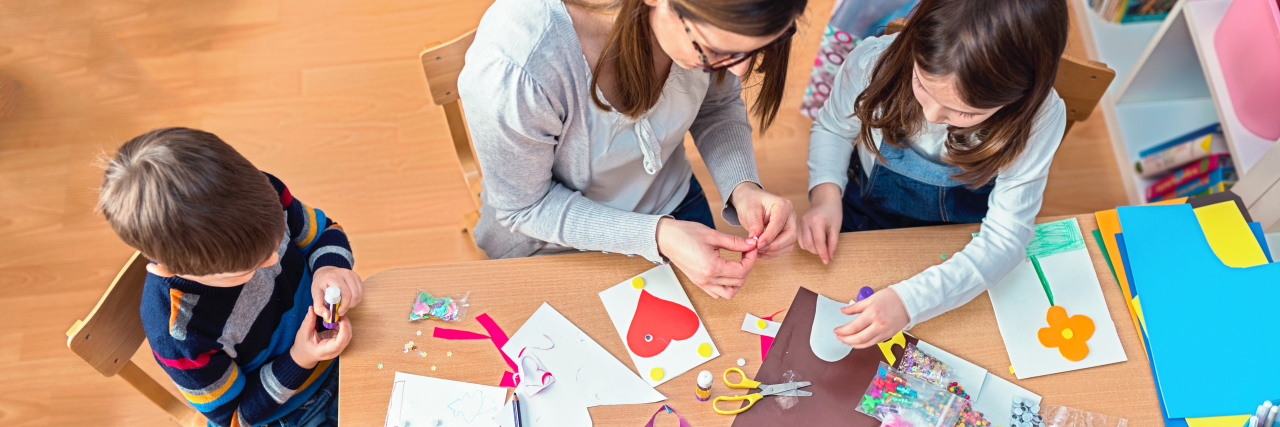 Mom doing art project with her kids.