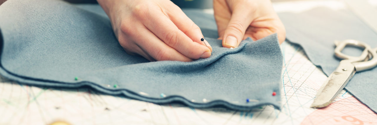 The Cost of Working in Public When You're Immunocompromised tailor marking the fabric with sewing pins