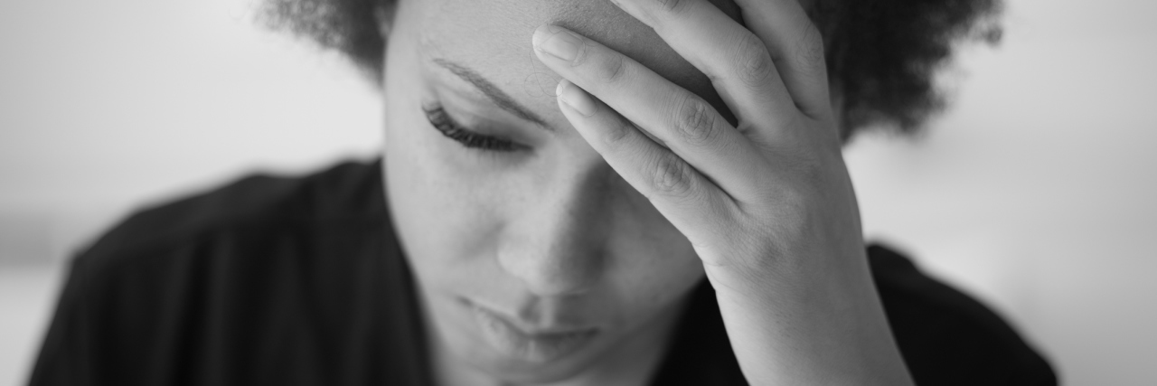 I'm Tired of Chronic Pain Making Me So Tired Tired african american woman touching her forehead and looking down.