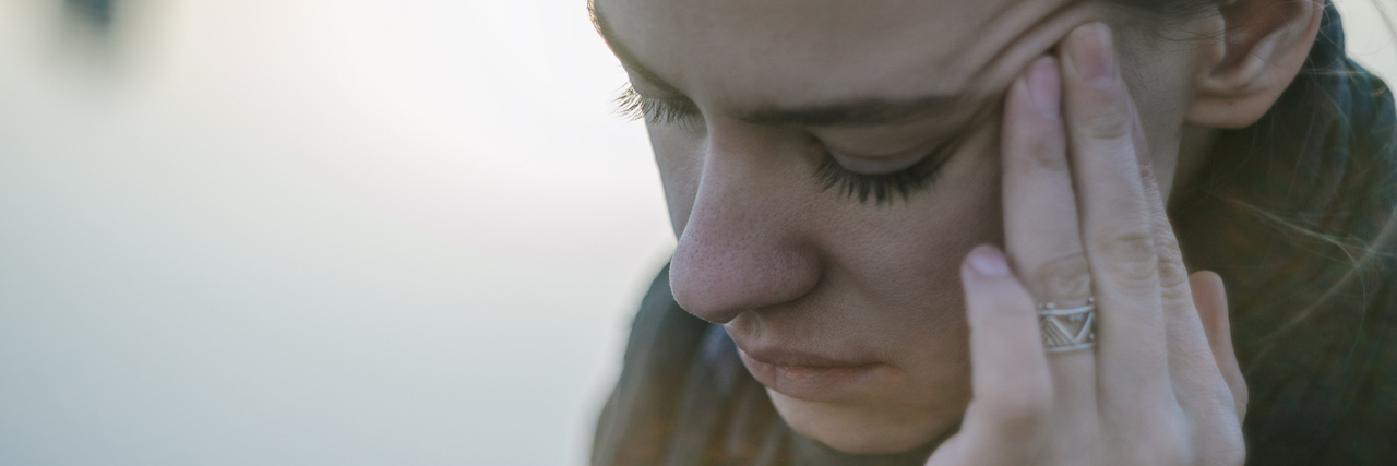 COVID-19 & Dermatillomania: Why It's Hard to Stop Touching My Face A woman touching her temple
