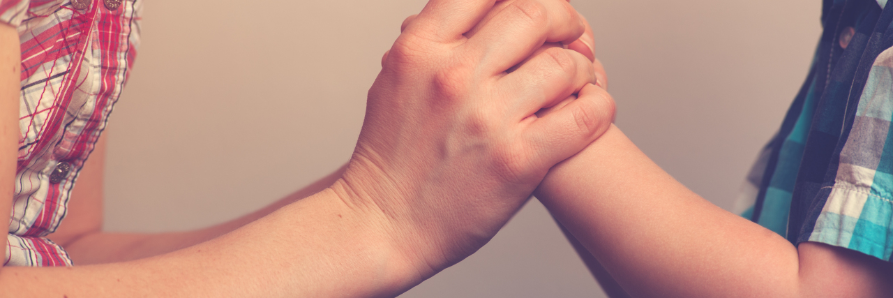 a closeup of a woman's hands and a child's hands