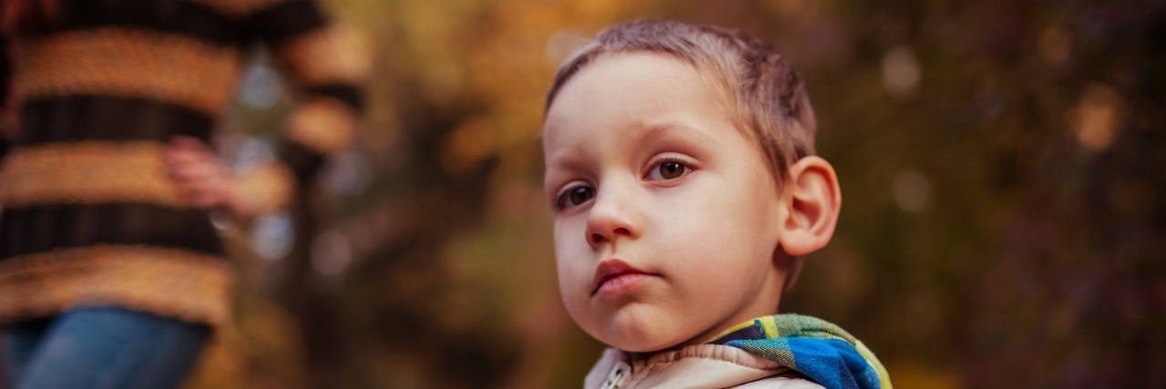 Staying Home for My Son With Klippel Feil Syndrome During COVID-19 little boy outside in the fall with a vest on