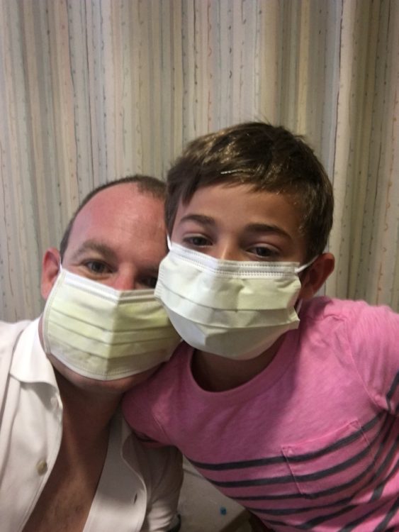 man and daughter wearing surgical masks