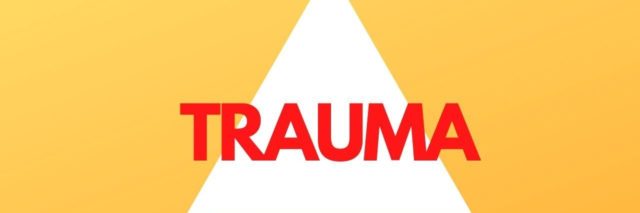 Photo of a white triangle on a yellow background with the words Trauma over it in red.