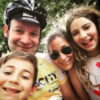 doug and his wife and two kids, doug is wearing a bike helmet
