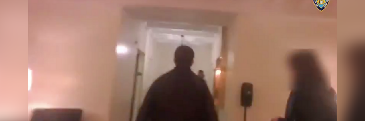 Screnshoot from body camera video showing a police officer in a man's home