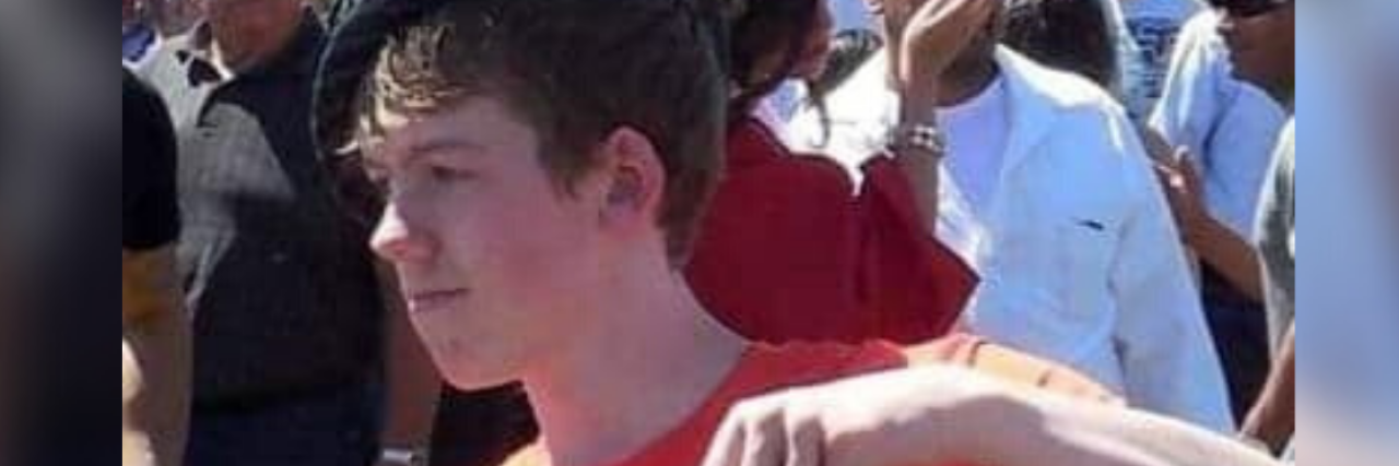 How Being Honest My Son Died by Suicide Has Helped Me photo of author's son in a red shirt and black top hat