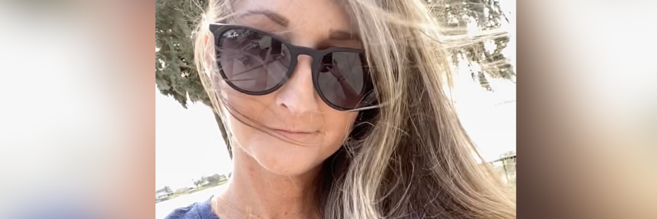 Don't Say I Don't 'Look Sick' Because My Chronic Illness Is Invisible selfie of author in sunglasses smiling