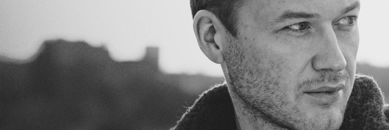 The Emotions That Define Getting Diagnosed With PTSD Black and white photo of a man looking to the side