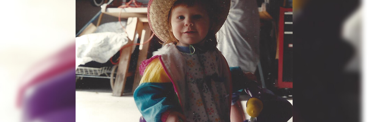 Why Accepting That My Mild Cerebral Palsy Is a Disability Matters Becca riding her tricycle