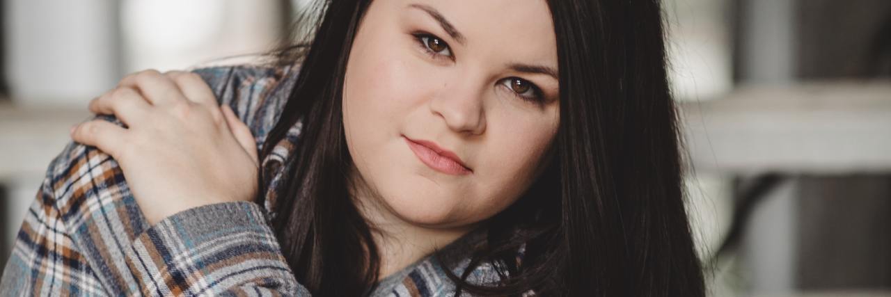 The Challenge of Physical Health Care When You Have an Eating Disorder photo of plus-size woman looking into camera with one hand on her shoulder