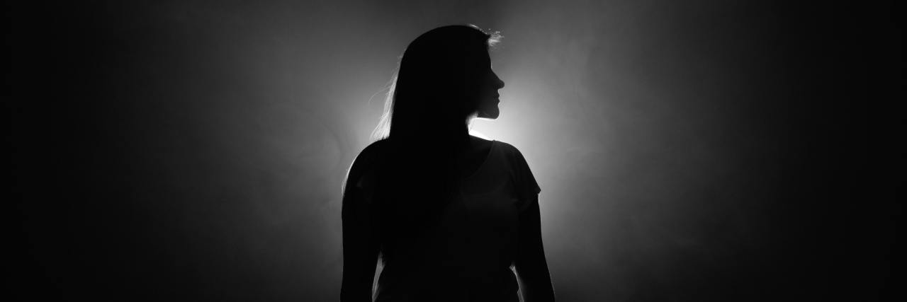 Read This If You Feel Suicidal and Alone black and white photo of woman silhouetted against white light in profile view