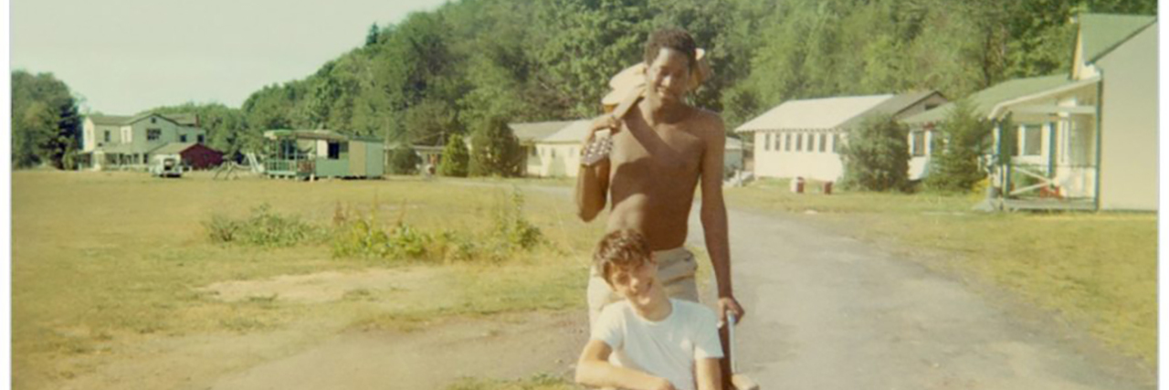 Review of Netflix's 'Crip Camp' From Someone With a Disability Crip Camp poster showing a vintage image of a man pushing another man in a wheelchair.