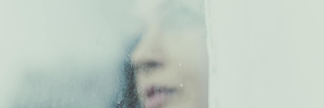 Why Borderline Personality Disorder Has Such High Suicide Rates blurry image of a woman's face looking away