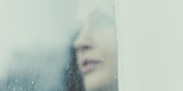 blurry image of a woman's face looking away