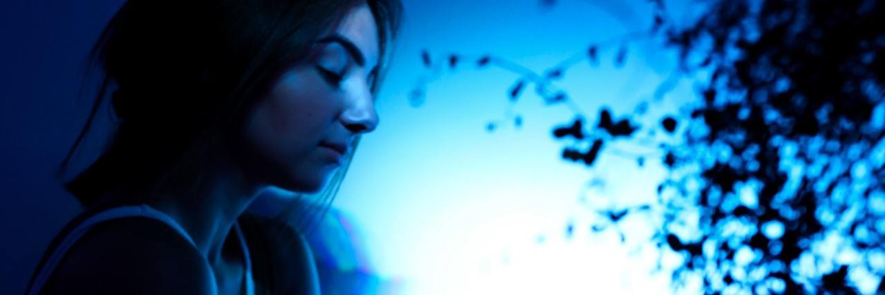 The '4 R's' of Social Distancing People With Depression Should Know woman looking at plant