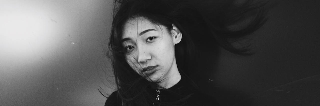 How the COVID-19 Pandemic Is Affecting My Depression Symptoms Black and white portrait of a woman with wind swept hair