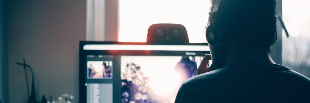 Remote Jobs for People With a Disability or Chronic Illness person editing photo on computer