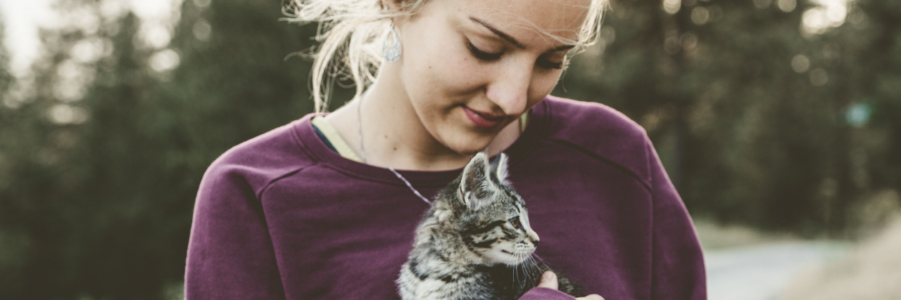 photo of a woman holding a kitten