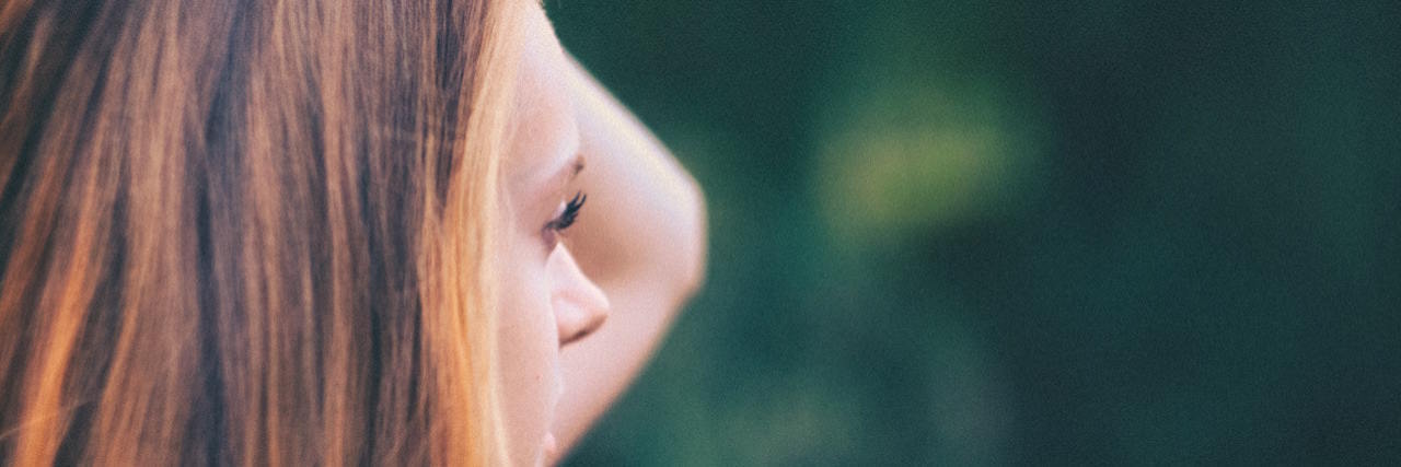 Profile of young woman looking into the distance