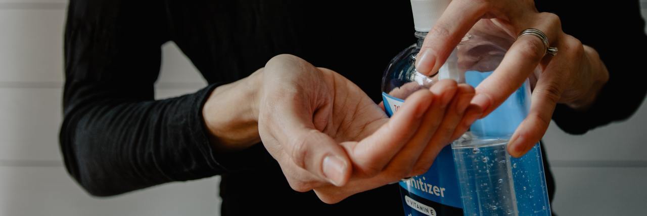 I'm Struggling With the Coronavirus Pandemic and Contamination OCD photo of woman cleaning hands with hand sanitizer