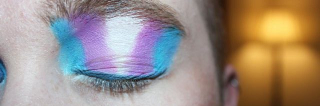 photo of person wearing trans flag eyeshadow