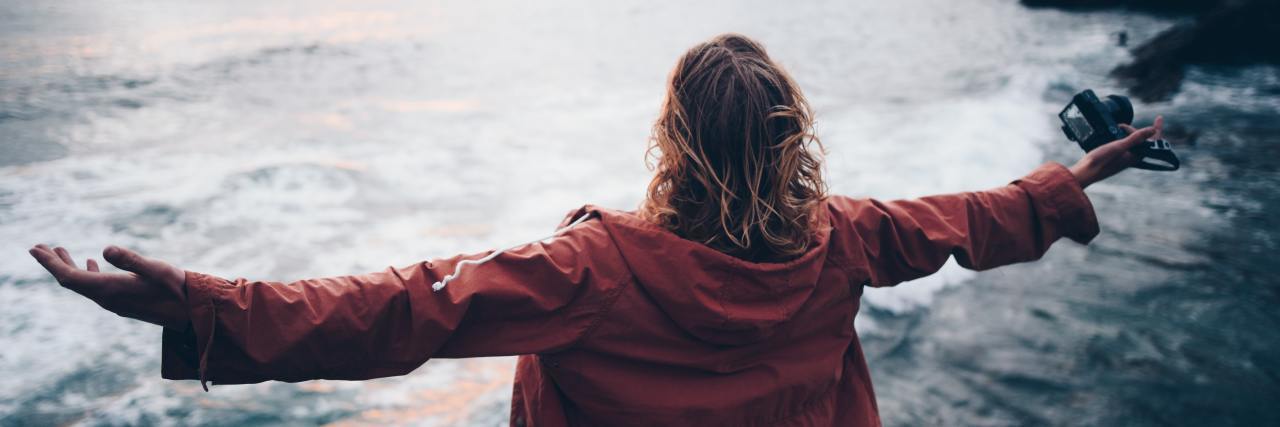 Read This If You Feel Guilty and Ashamed of Life With Mental Illness photo of woman standing by shore with outstretched arms