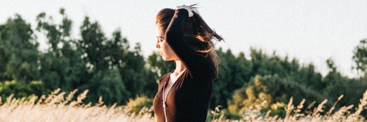 Anxiety Makes Me Feel Guilty About Possibly Upsetting Others photo of young woman in field looking away from camera toward sun