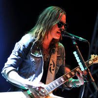 Lzzy Hale performs onstage with her guitar.