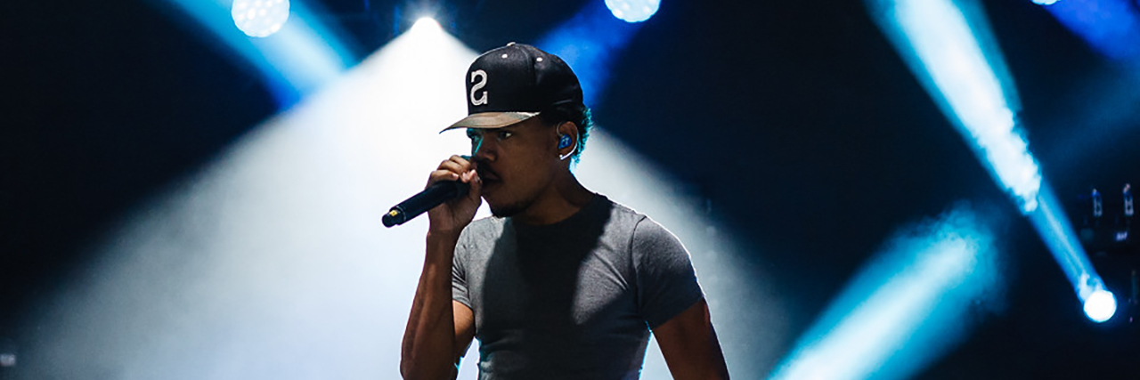 Chance the Rapper performing at a concert.