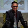 Robert Downey Jr smiles while he prepares for a panel