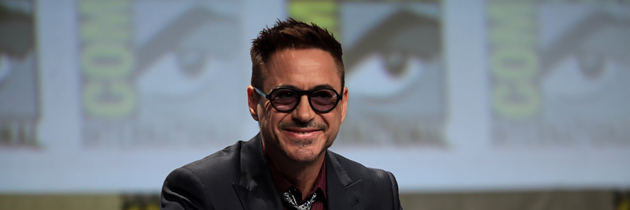 Robert Downey Jr. Raises Awareness for ROHHADs on Rare Disease Day Robert Downey Jr smiles while he prepares for a panel