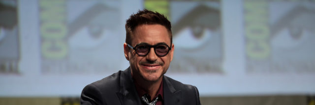 Robert Downey Jr smiles while he prepares for a panel
