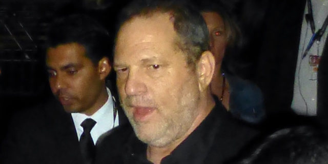 Harvey Weinstein surrounded by a crowd