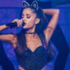 Ariana Grande performs onstage while wearing bunny ears