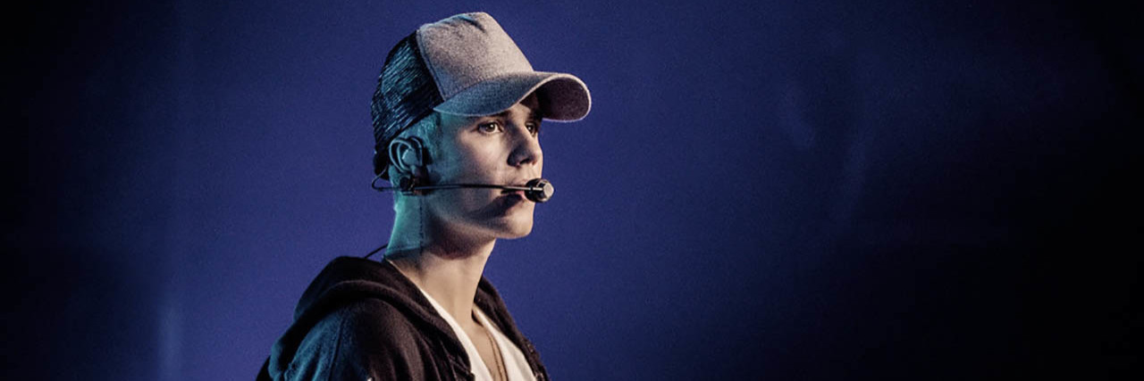 Justin Bieber Reveals Lyme Disease Diagnosis Just Bieber performs onstage against a purple backdrop