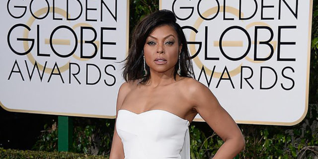Taraji Henson poses in a white dress on the Golden Globes red carpet