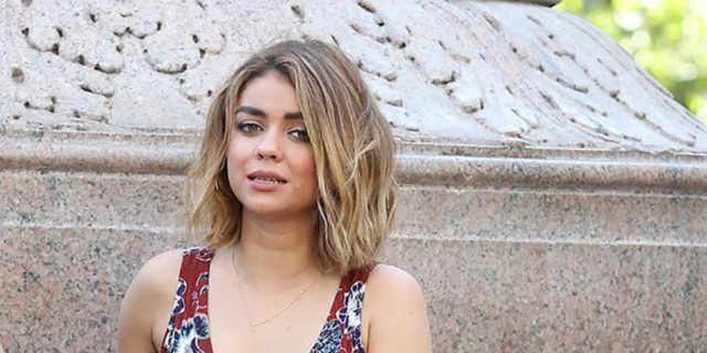 Sarah Hyland wears a red, blue and white dress on set of Modern Family